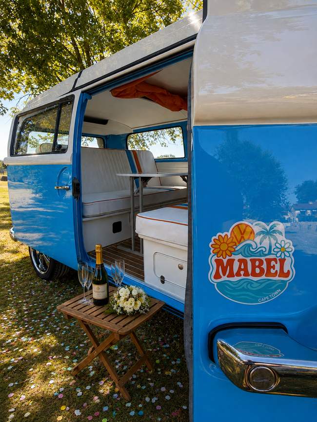 A toast at the picnic table, Mabel parked up for the evening.